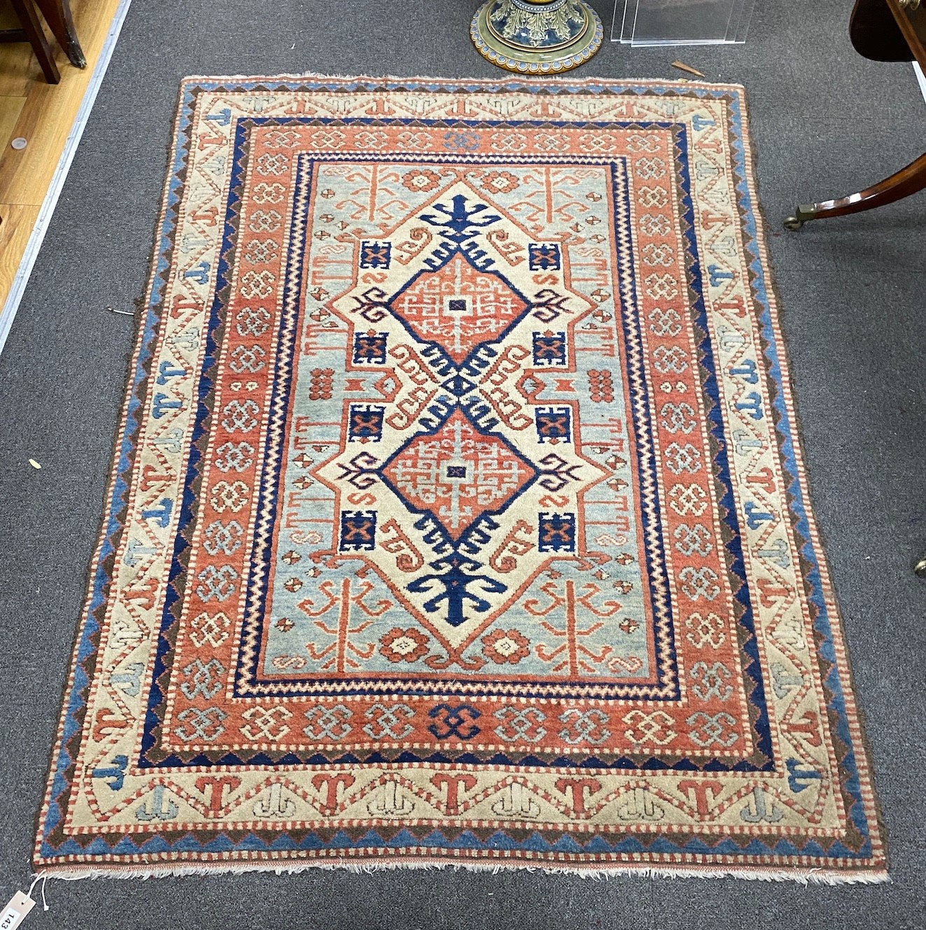 A Caucasian style ivory ground rug, 188 x 133cm